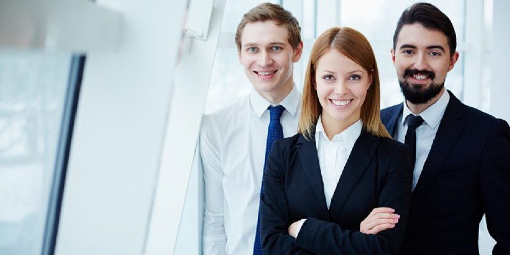 Three successful business partners looking at camera with smiles