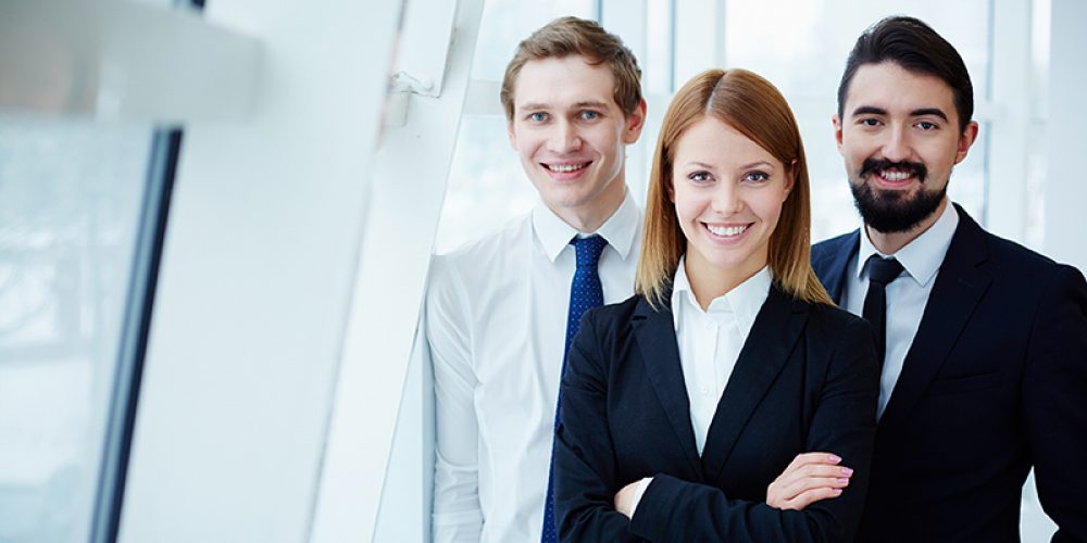 Three successful business partners looking at camera with smiles