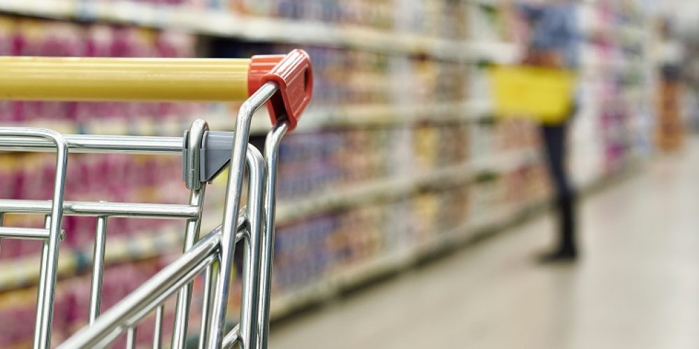 Cart buyer in supermarket close-up