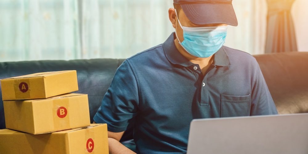 Asian man online sales. The seller prepares the delivery box for the customer, or ecommerce. concept prevent the spread of germs and bacteria and avoid infections corona virus [Covid-19]