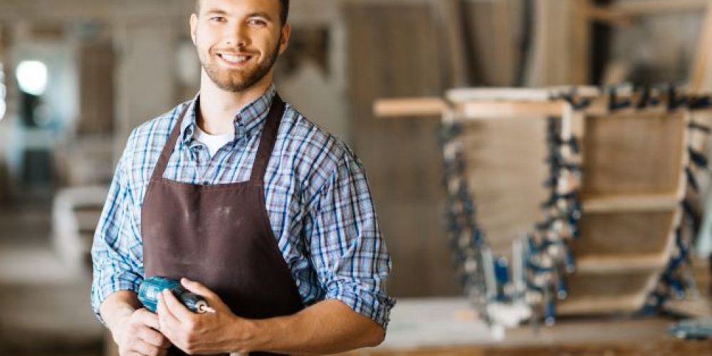 smiling-craftsman-with-electric-drill